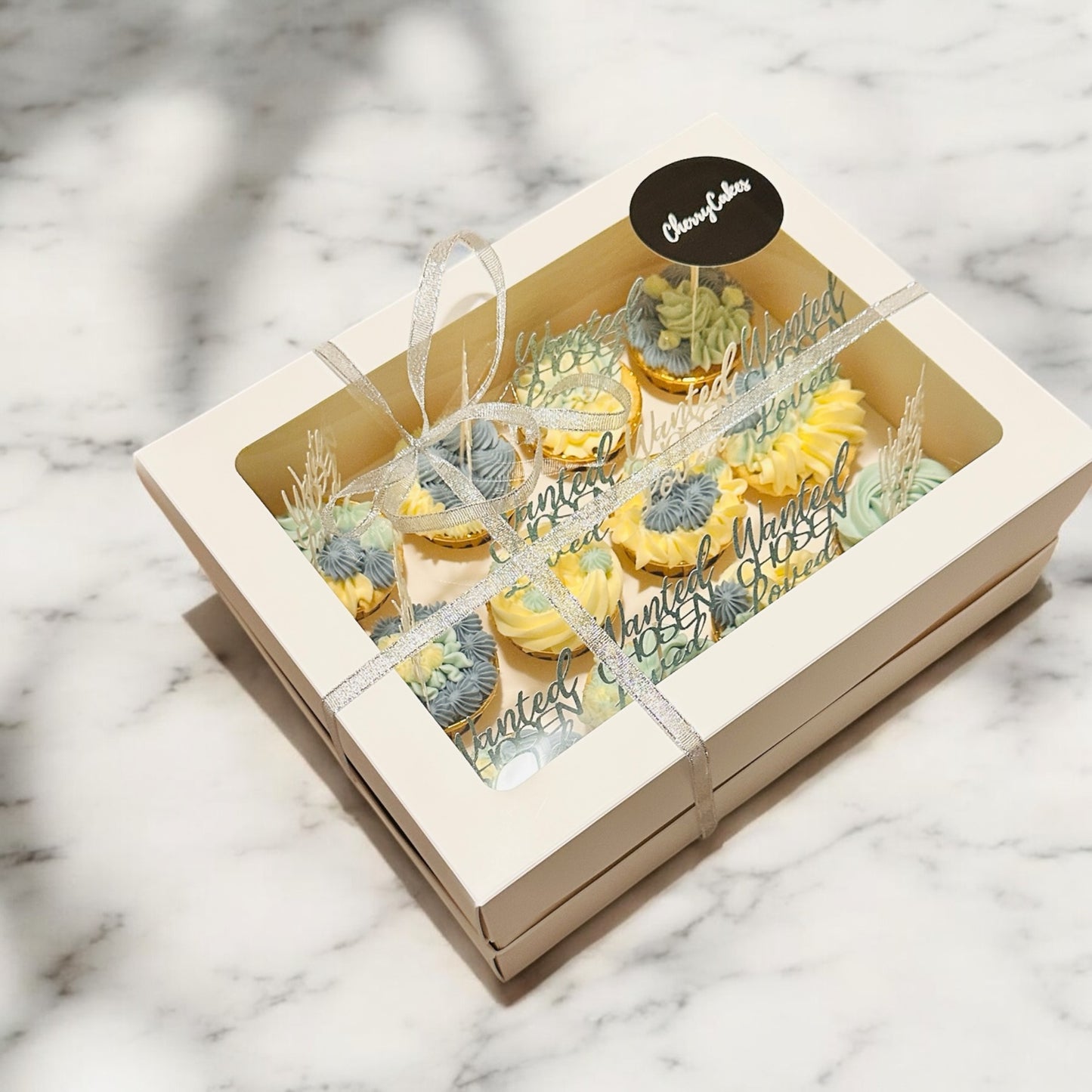 Bespoke 12 blue/white cupcakes