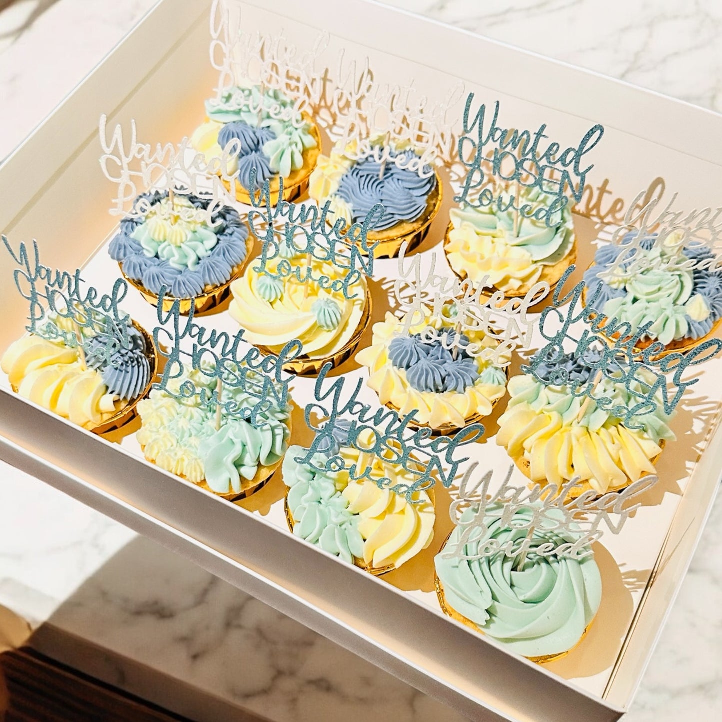 Bespoke 12 blue/white cupcakes
