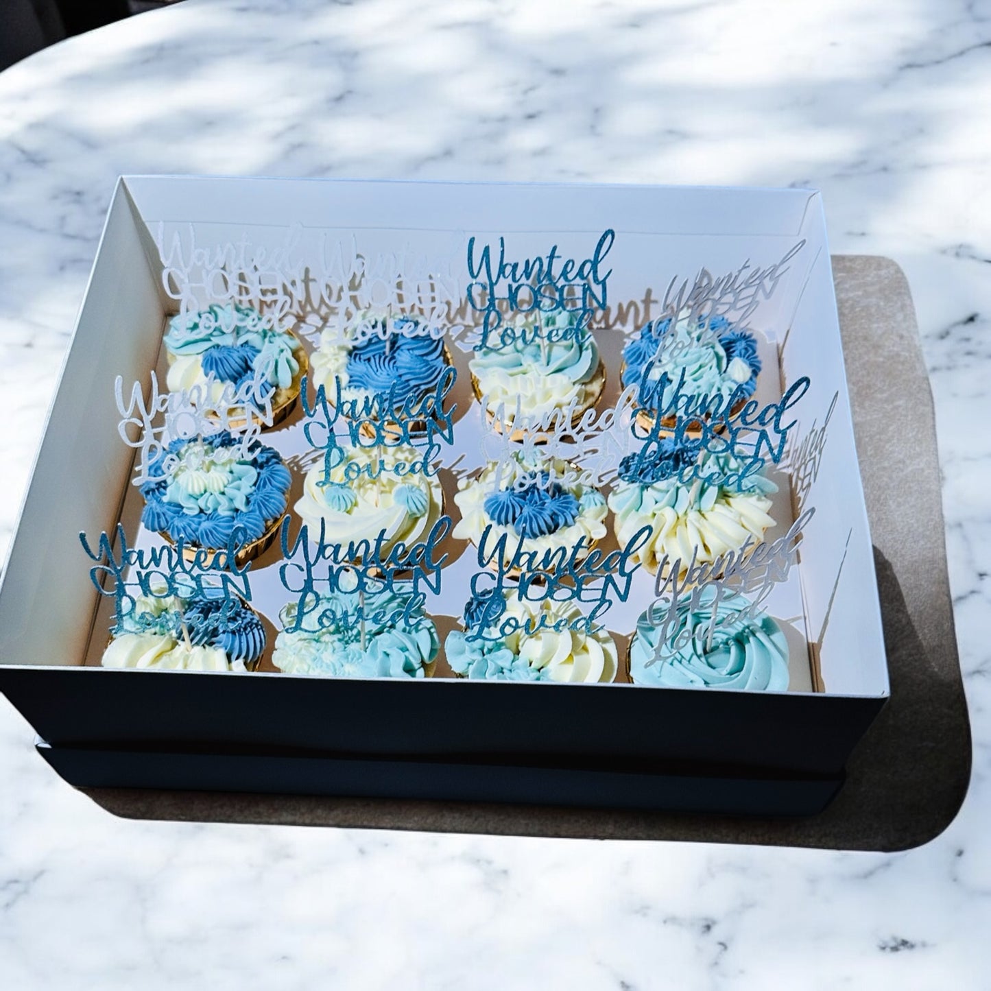 Bespoke 12 blue/white cupcakes